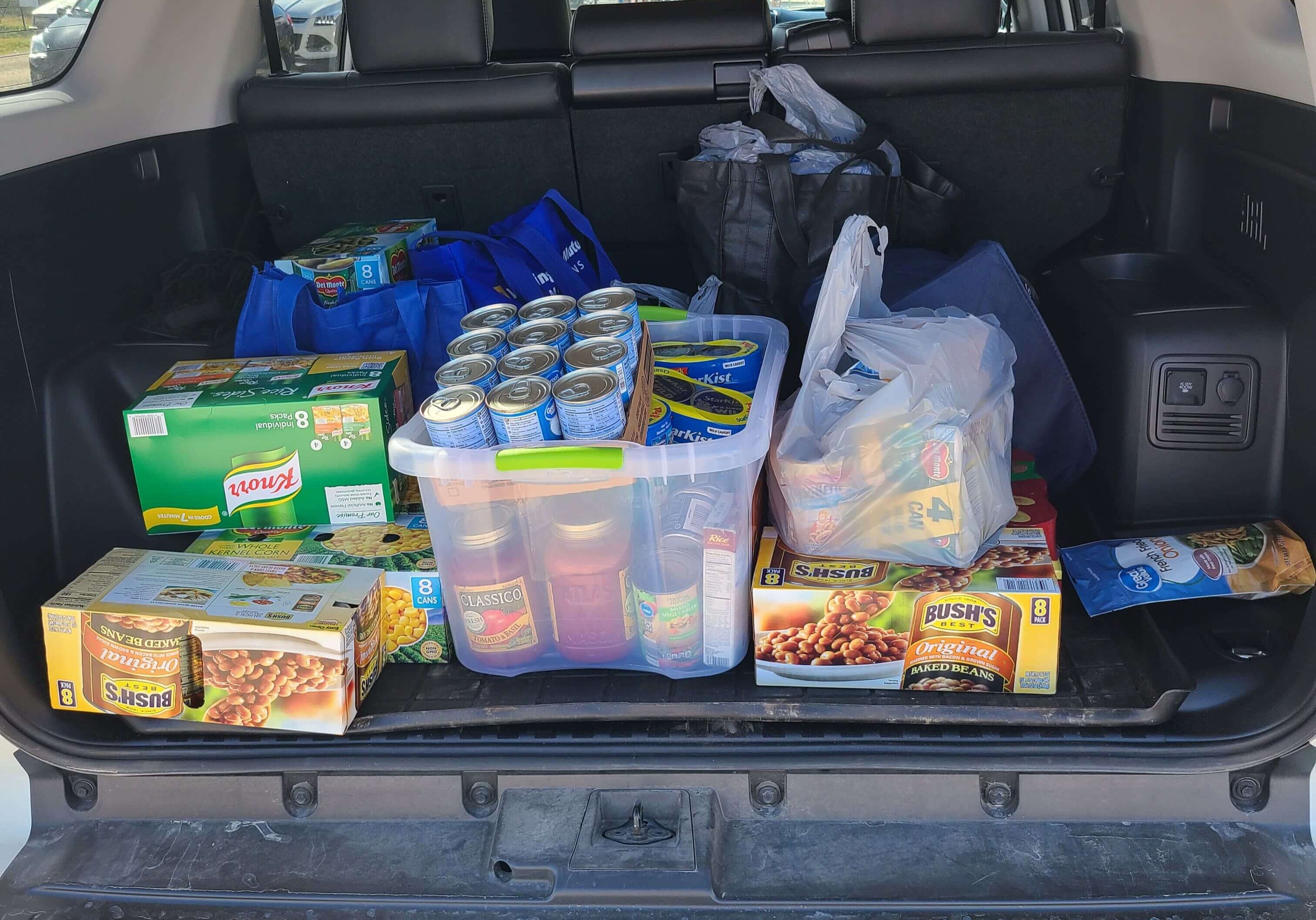 A trunk full of Thanksgiving food and canned goods.